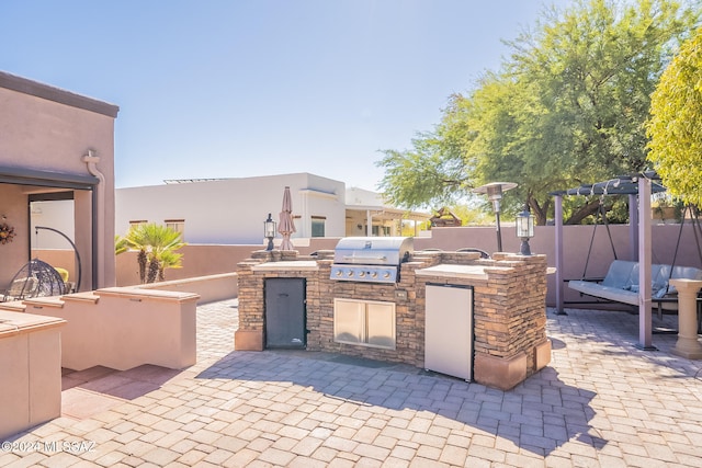 view of patio / terrace featuring grilling area and an outdoor kitchen