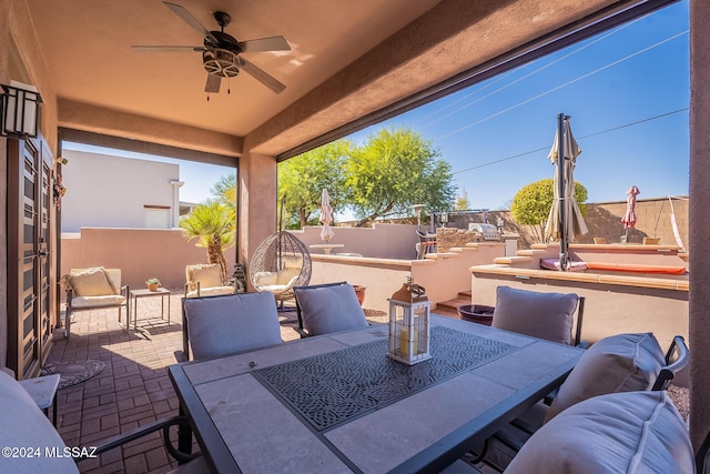 view of patio with fence private yard, ceiling fan, and outdoor dining area