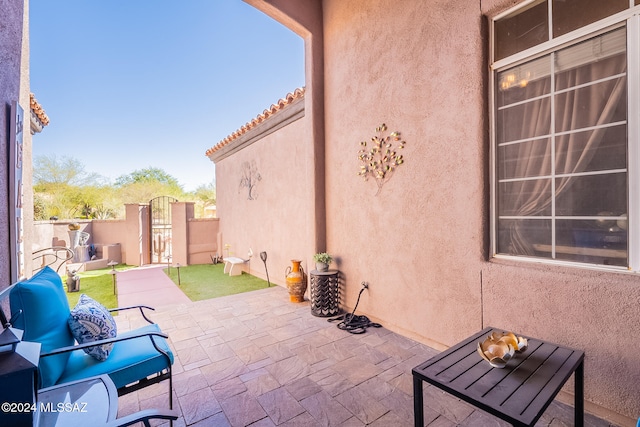 view of patio featuring a gate and fence