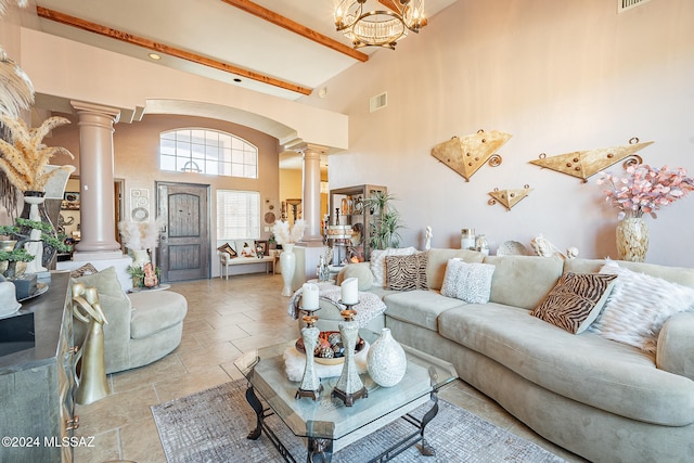 living room featuring ornate columns, beamed ceiling, a chandelier, and a high ceiling