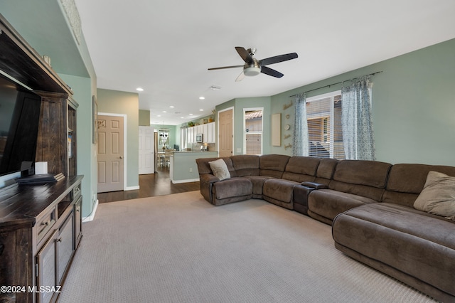 living room featuring dark wood-type flooring and ceiling fan