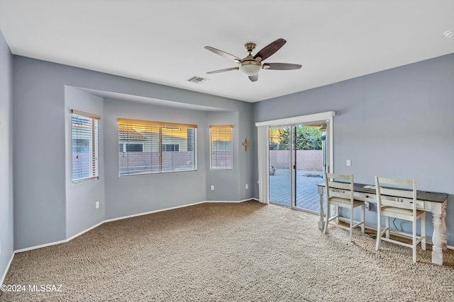 interior space with ceiling fan and carpet