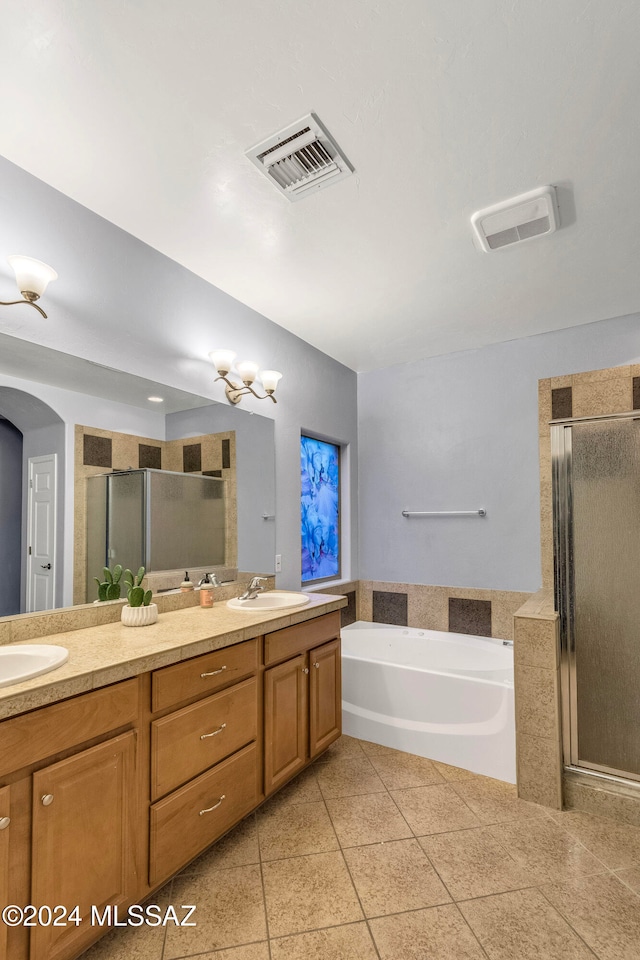 bathroom featuring tile patterned flooring, vanity, and separate shower and tub