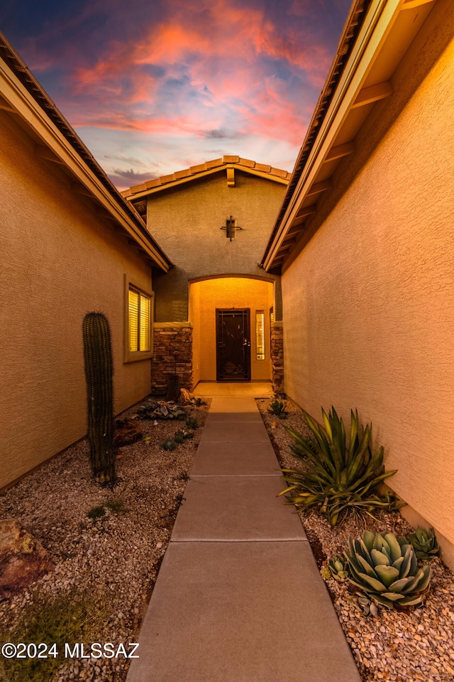 view of exterior entry at dusk