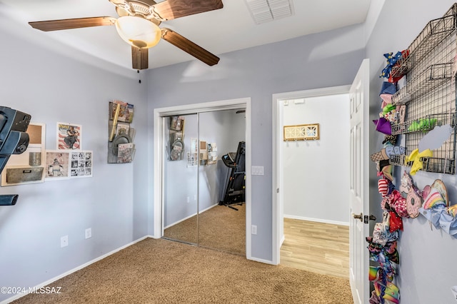 bedroom with carpet, ceiling fan, and a closet