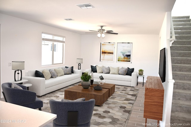 living room with light hardwood / wood-style floors and ceiling fan