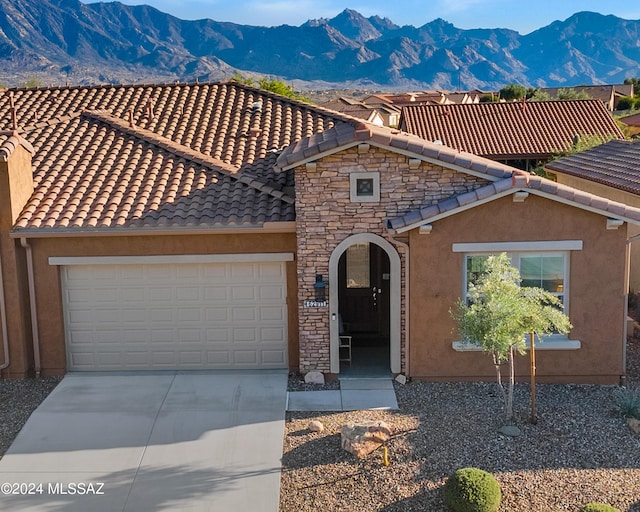 view of front of home featuring a mountain view and a garage