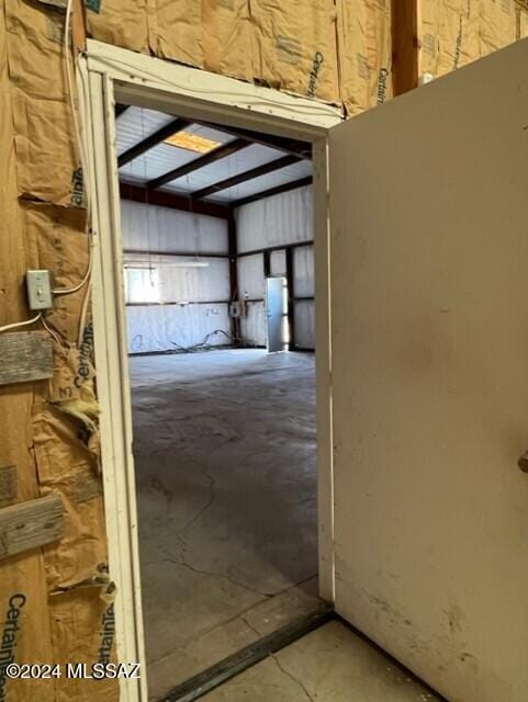 hallway with concrete floors