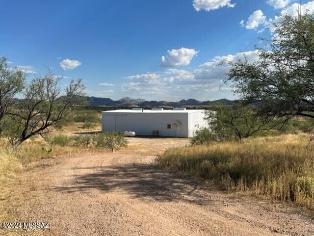 view of property exterior with a mountain view