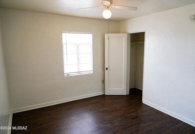 unfurnished bedroom featuring ceiling fan, a closet, and dark hardwood / wood-style flooring