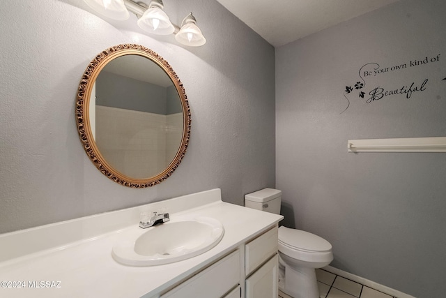 bathroom featuring tile patterned flooring, vanity, and toilet