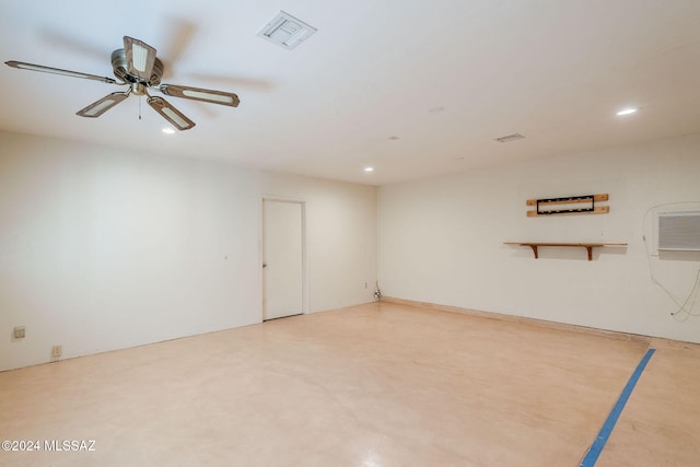 empty room with ceiling fan and concrete floors