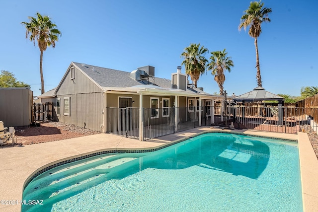 view of swimming pool featuring a patio area and a gazebo