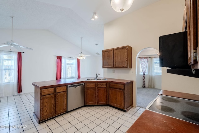 kitchen featuring kitchen peninsula, a wealth of natural light, and stainless steel dishwasher