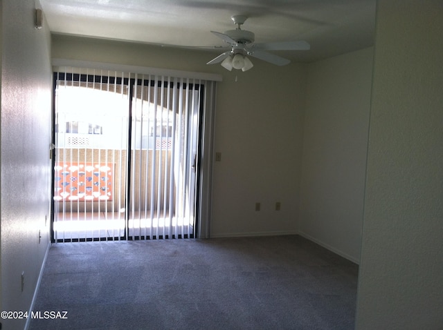 carpeted empty room featuring ceiling fan