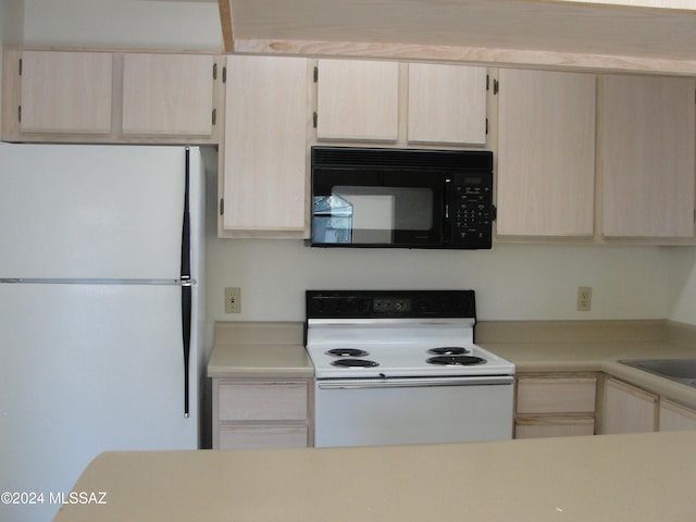 kitchen with light brown cabinets and white appliances