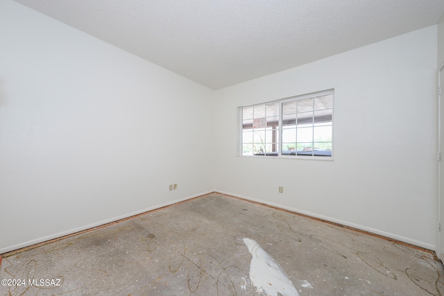 empty room featuring a textured ceiling