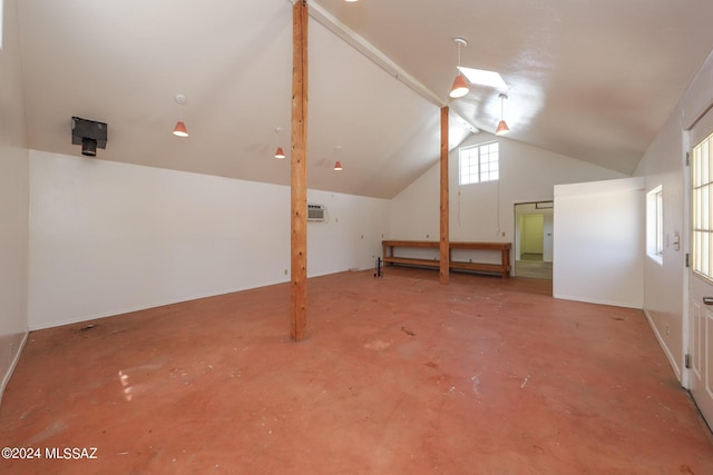 bonus room with concrete floors and lofted ceiling