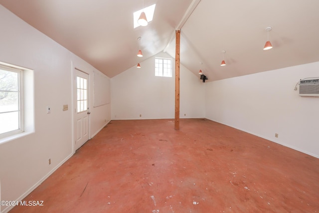 additional living space featuring a wall mounted AC, a wealth of natural light, and lofted ceiling