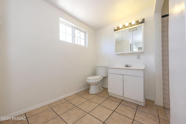 bathroom with tile patterned floors, vanity, and toilet