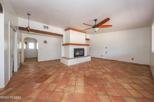 unfurnished living room featuring ceiling fan