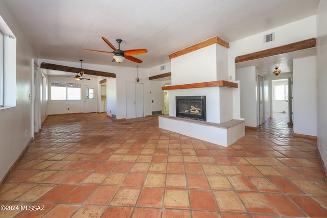 unfurnished living room featuring ceiling fan