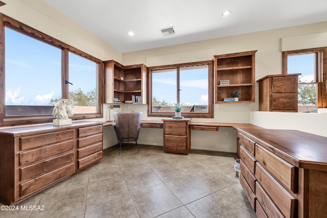 office space with recessed lighting, built in study area, visible vents, and light tile patterned floors