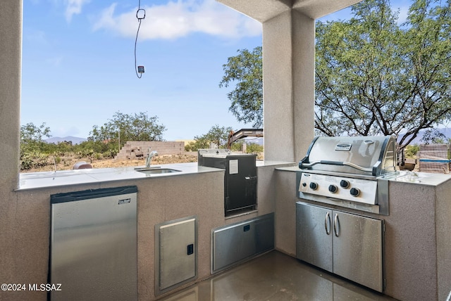 view of patio with grilling area, a sink, and area for grilling