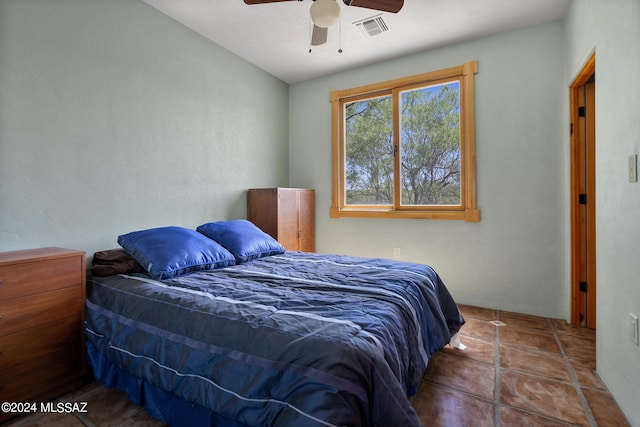 tiled bedroom featuring ceiling fan and visible vents