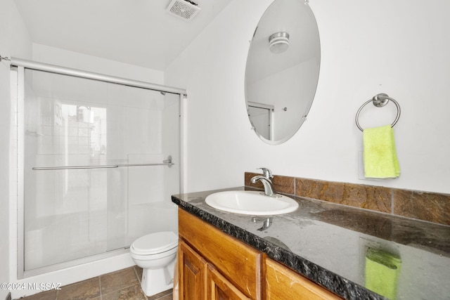 full bath with toilet, a stall shower, vanity, and visible vents