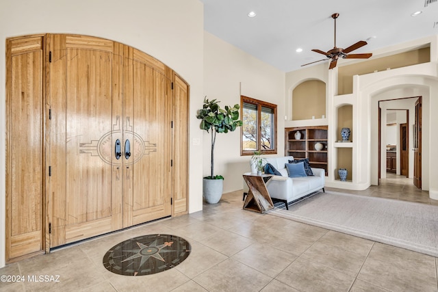 foyer entrance featuring arched walkways, recessed lighting, and light tile patterned floors