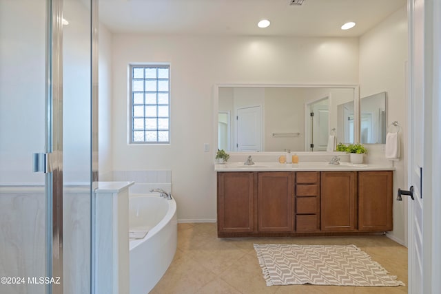 bathroom featuring shower with separate bathtub, vanity, and tile patterned flooring