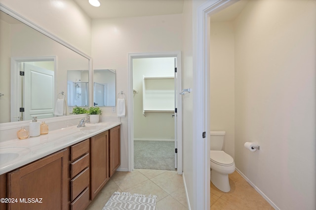 bathroom featuring tile patterned flooring, vanity, and toilet