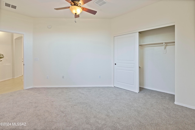 unfurnished bedroom with carpet flooring, ceiling fan, and a closet