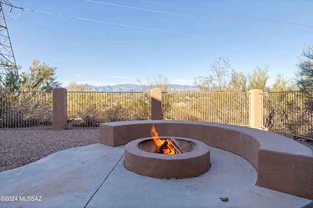 view of patio / terrace with a fire pit and a mountain view