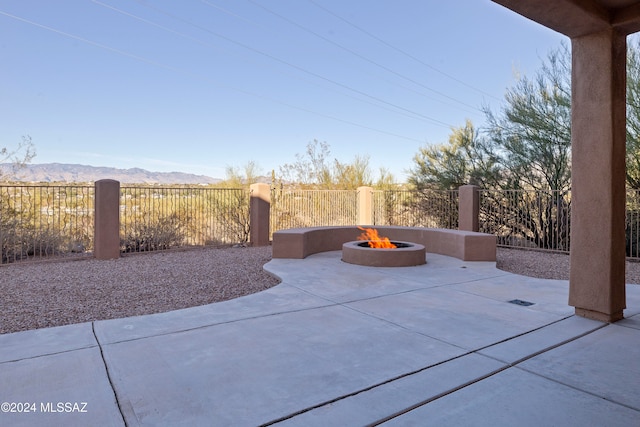 view of patio / terrace featuring a mountain view and an outdoor fire pit