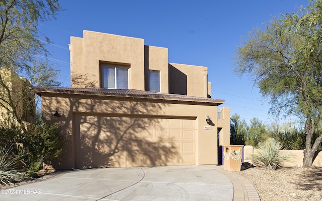 adobe home featuring a garage