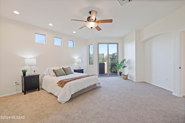 bedroom featuring access to outside, light colored carpet, and ceiling fan