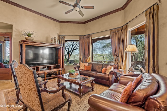 living room featuring light hardwood / wood-style flooring, ceiling fan, and crown molding