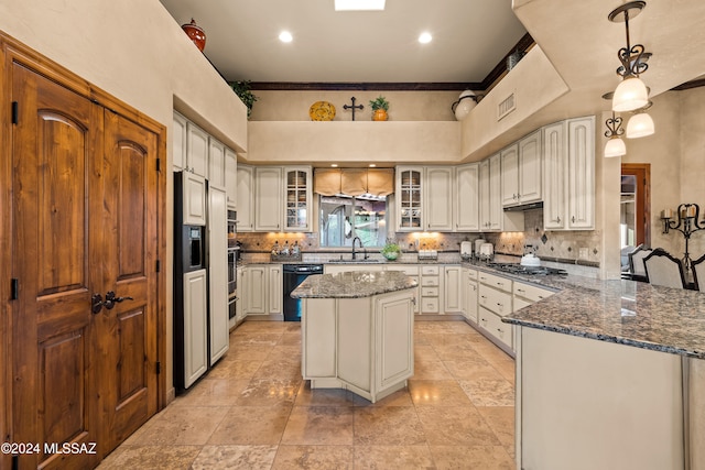 kitchen with sink, ornamental molding, hanging light fixtures, a center island, and dishwasher