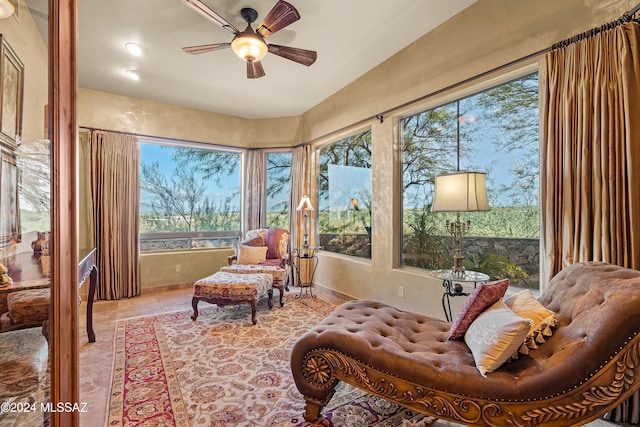 interior space with ceiling fan