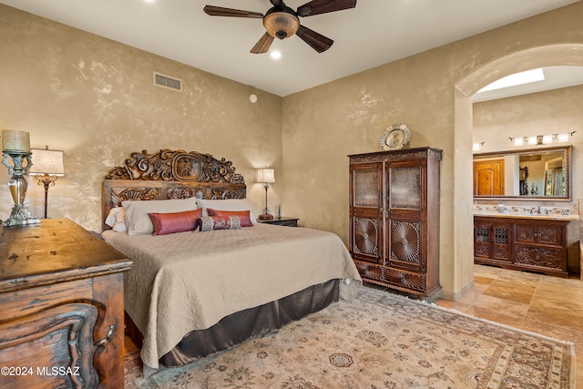 bedroom featuring ceiling fan and ensuite bath