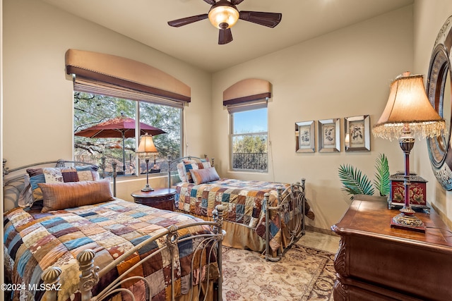 bedroom featuring ceiling fan and vaulted ceiling