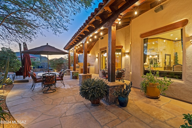 view of patio terrace at dusk