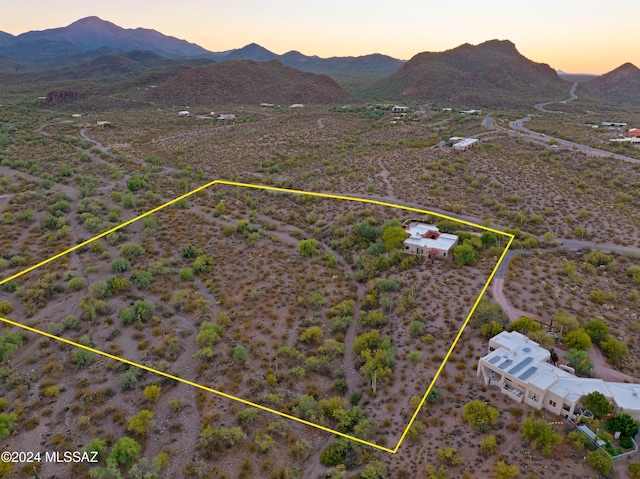 aerial view at dusk featuring a mountain view