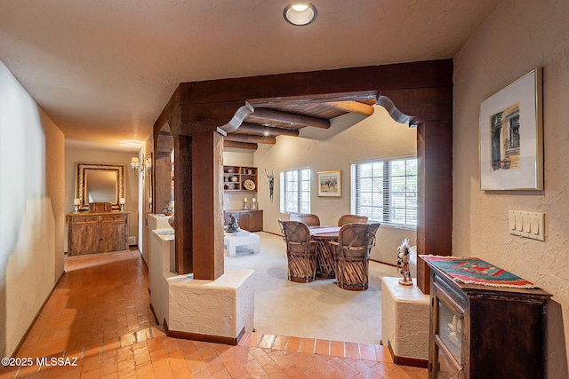 dining room featuring beam ceiling and wooden ceiling