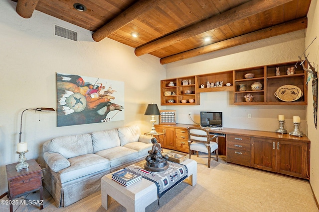 carpeted living room with beamed ceiling, built in desk, and wooden ceiling