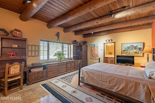 bedroom with beam ceiling, ensuite bathroom, track lighting, and wooden ceiling