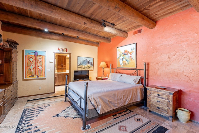 bedroom featuring ensuite bathroom, beam ceiling, wood ceiling, and rail lighting