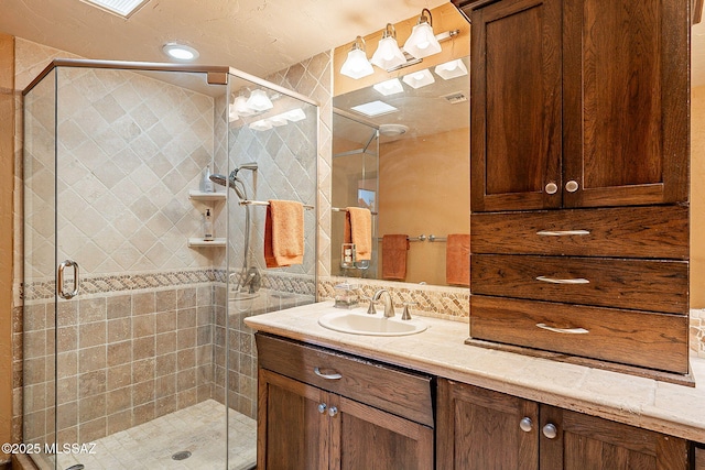 bathroom with vanity and an enclosed shower